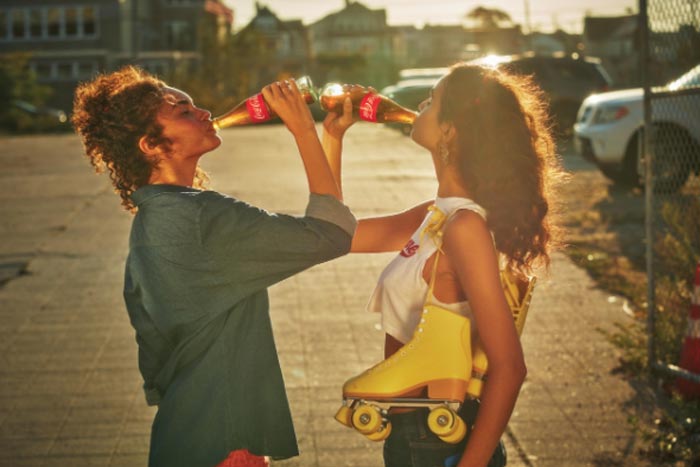 two girls drinking coke